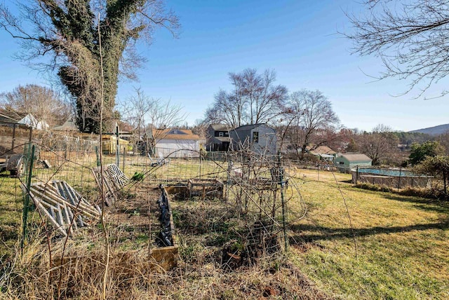 view of yard featuring a vegetable garden and fence