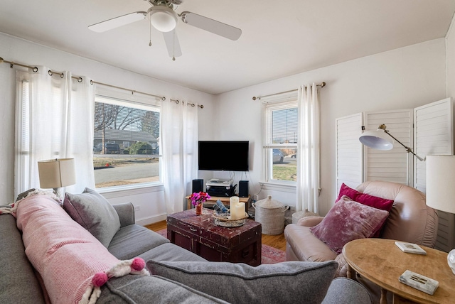 living area featuring a ceiling fan and wood finished floors