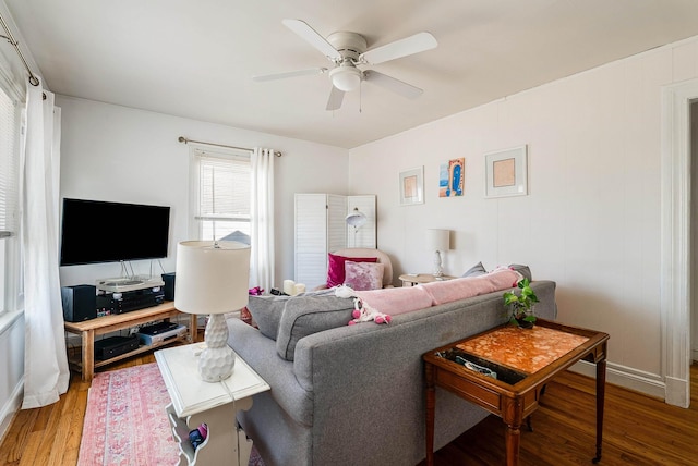 living area with wood finished floors and a ceiling fan