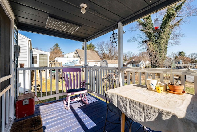 wooden deck featuring an outbuilding and a residential view