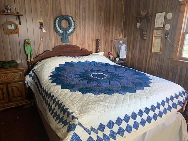 bedroom with wood walls