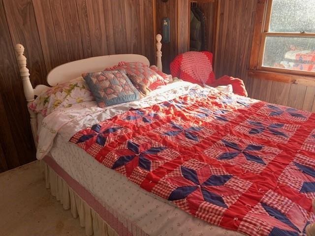 bedroom with carpet and wood walls