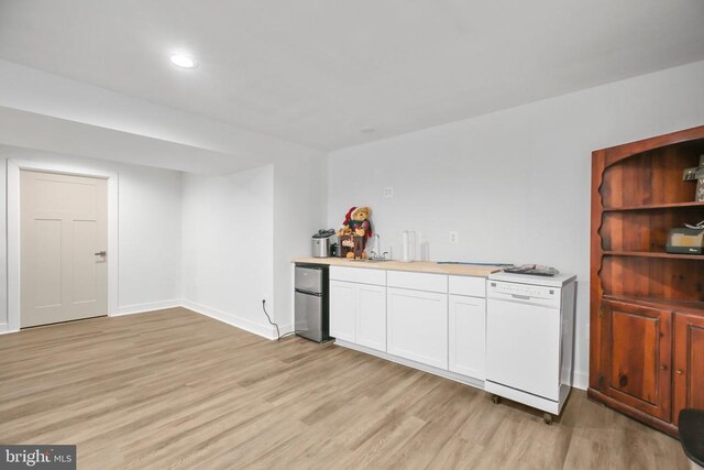 bar featuring white cabinetry, stainless steel fridge, dishwasher, and light wood-type flooring