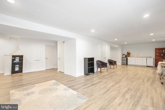 interior space featuring indoor bar and light hardwood / wood-style flooring