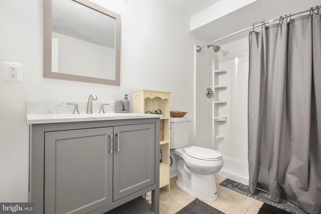 bathroom featuring vanity, curtained shower, tile patterned floors, and toilet