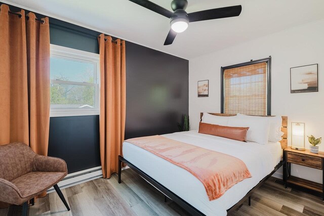 bedroom featuring light wood-type flooring and ceiling fan