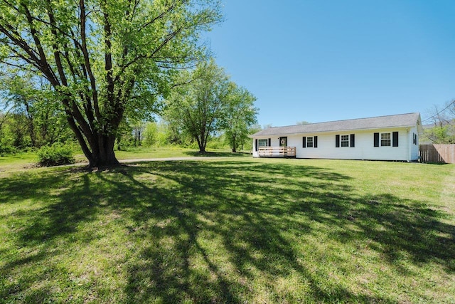 view of yard featuring fence and a deck