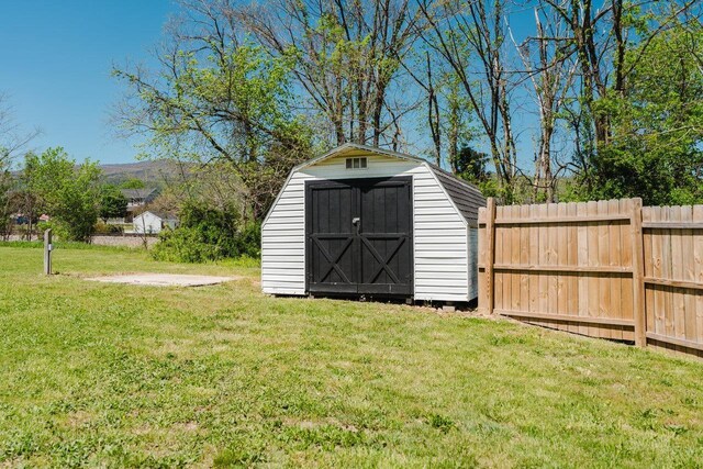 view of shed with fence