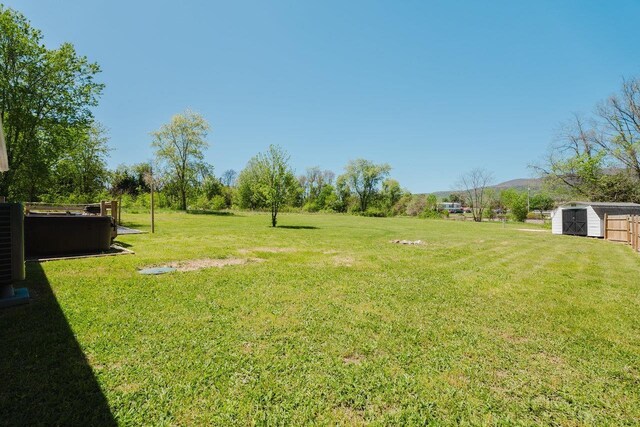 view of yard with a storage shed and an outbuilding