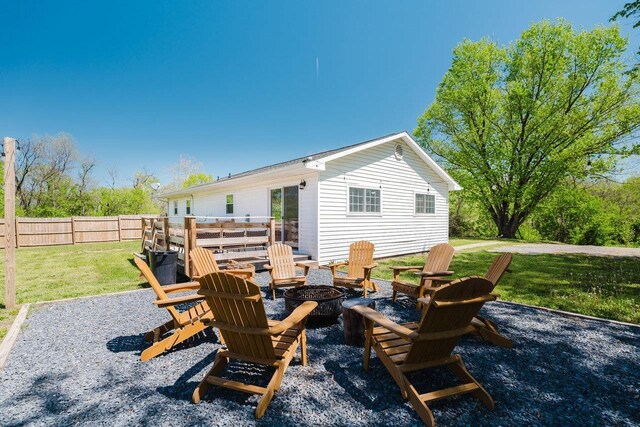 view of patio / terrace featuring fence and a fire pit