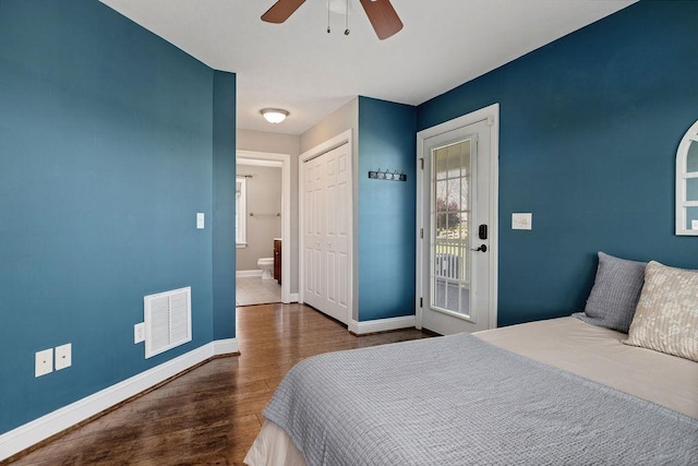 bedroom featuring a ceiling fan, baseboards, wood finished floors, visible vents, and a closet