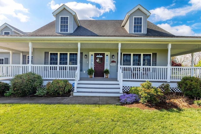 view of front of property with a shingled roof, a porch, and a front lawn