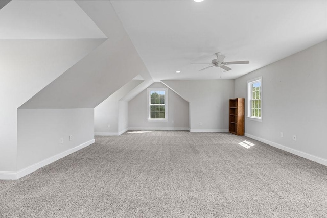 bonus room featuring baseboards, plenty of natural light, vaulted ceiling, and ceiling fan