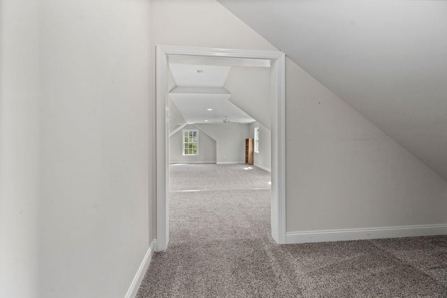 bonus room featuring baseboards, vaulted ceiling, and carpet