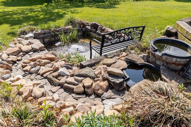 view of yard featuring a garden pond