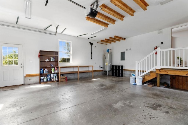 garage with a garage door opener, water heater, and electric panel