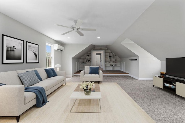 living room featuring built in features, baseboards, an AC wall unit, a ceiling fan, and vaulted ceiling
