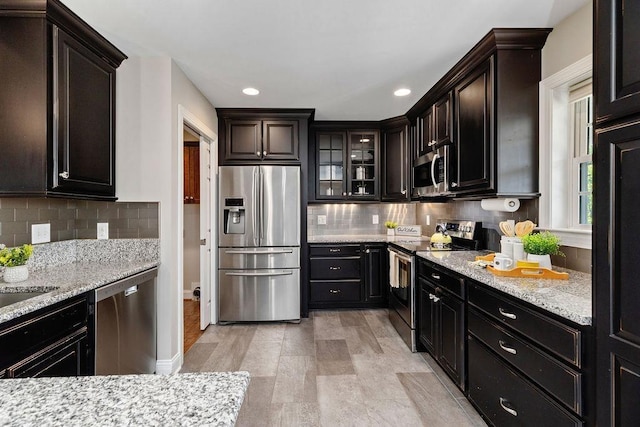 kitchen featuring recessed lighting, decorative backsplash, and stainless steel appliances