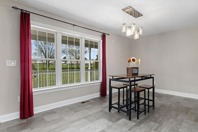 dining room with visible vents, a chandelier, and a healthy amount of sunlight