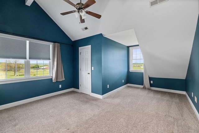additional living space featuring carpet floors, visible vents, and vaulted ceiling