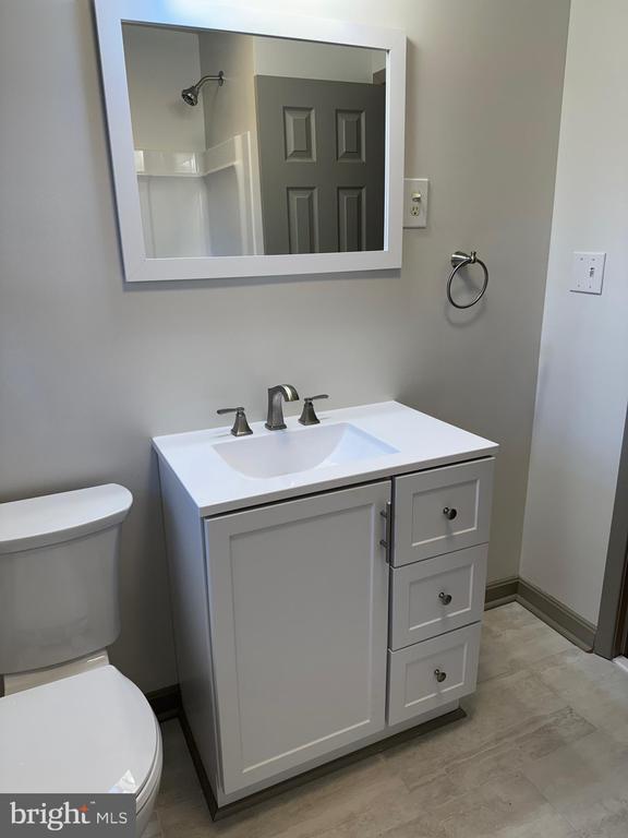 details featuring light stone countertops and sink