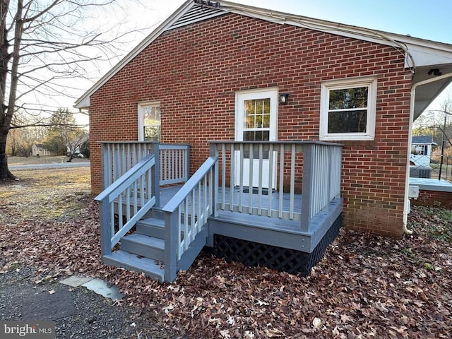 rear view of house featuring a wooden deck