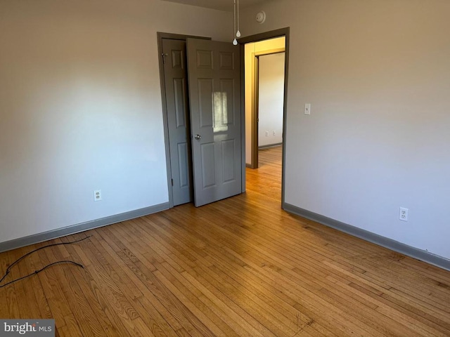 unfurnished room with light wood-type flooring