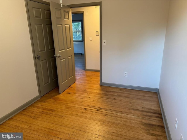 empty room with light hardwood / wood-style floors