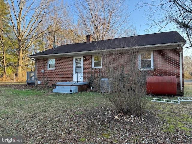 rear view of house with a yard