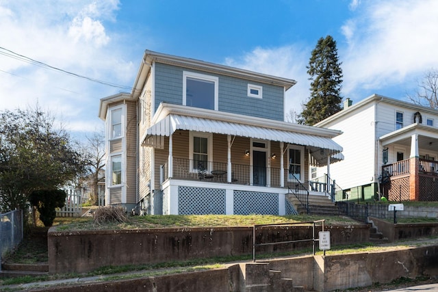 view of front of property with fence and covered porch