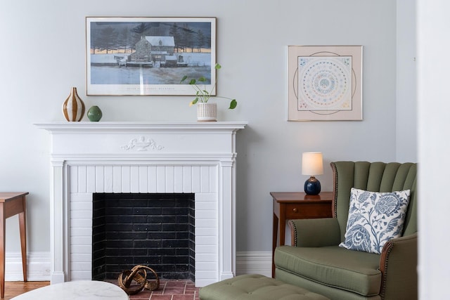 sitting room with a brick fireplace