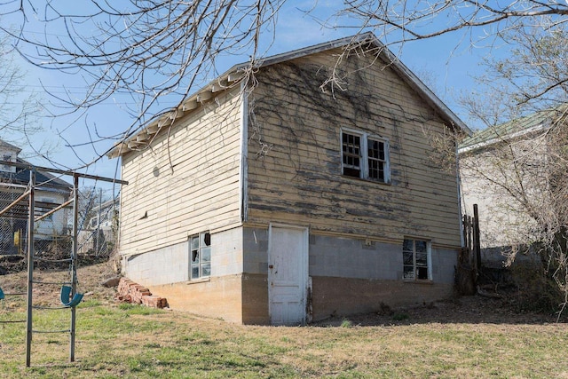 rear view of house featuring a lawn