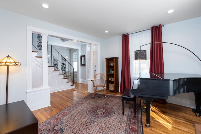 interior space with recessed lighting, wood finished floors, and ornate columns