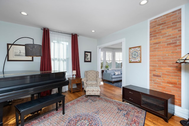 living area with recessed lighting, light wood-type flooring, and a wealth of natural light