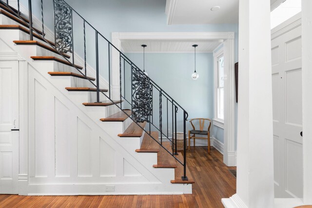 stairway with baseboards and wood finished floors