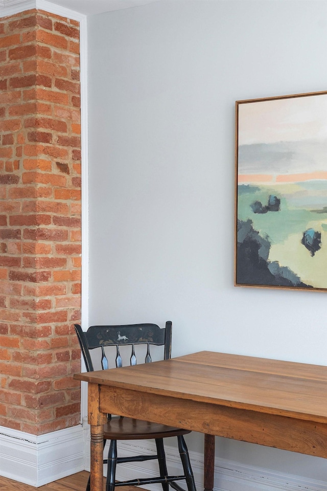 dining area featuring brick wall