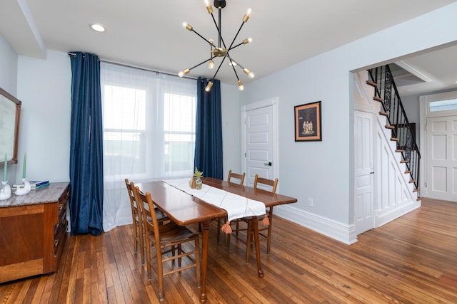 dining room with hardwood / wood-style flooring, recessed lighting, stairway, baseboards, and a chandelier