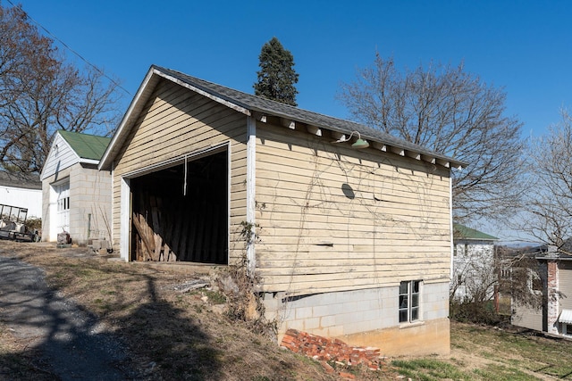 view of side of home with an outbuilding