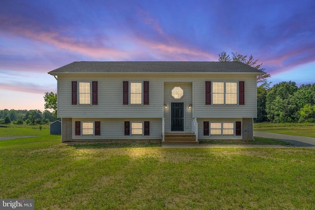 split foyer home featuring a lawn