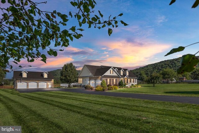 view of front of house with a garage and a lawn