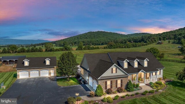 view of front of property with a garage and a mountain view