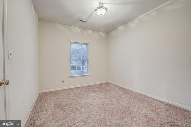 empty room featuring light carpet