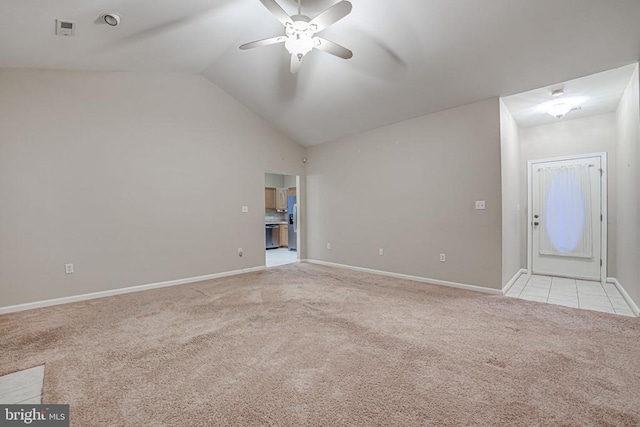 carpeted spare room featuring ceiling fan and vaulted ceiling