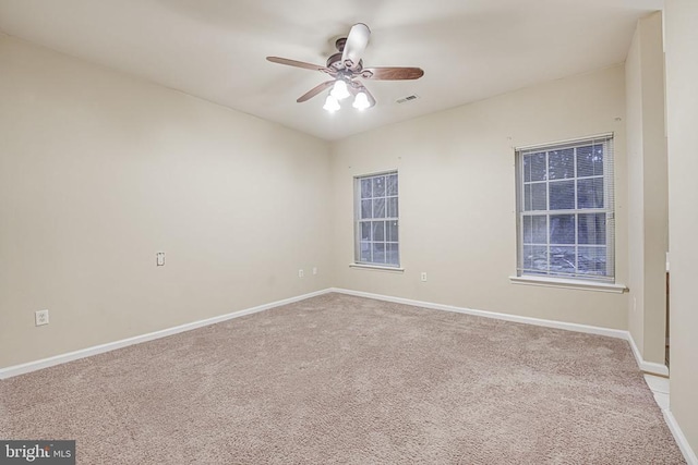 empty room with light colored carpet and ceiling fan