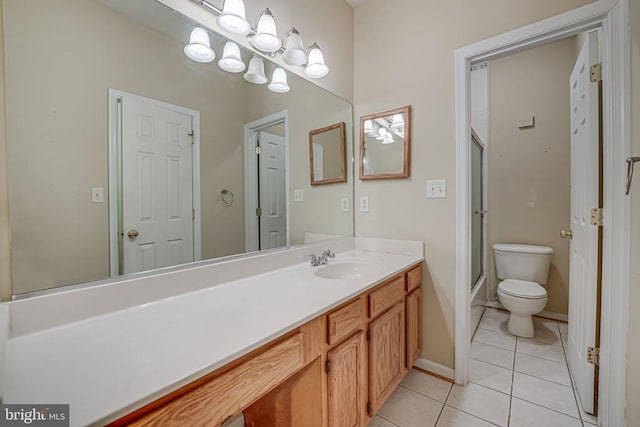 bathroom featuring tile patterned floors, toilet, a shower with shower door, and vanity