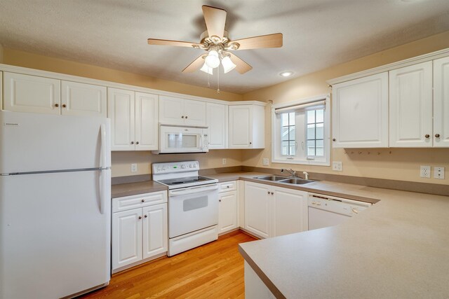 kitchen featuring sink, white appliances, ceiling fan, white cabinets, and light wood-type flooring