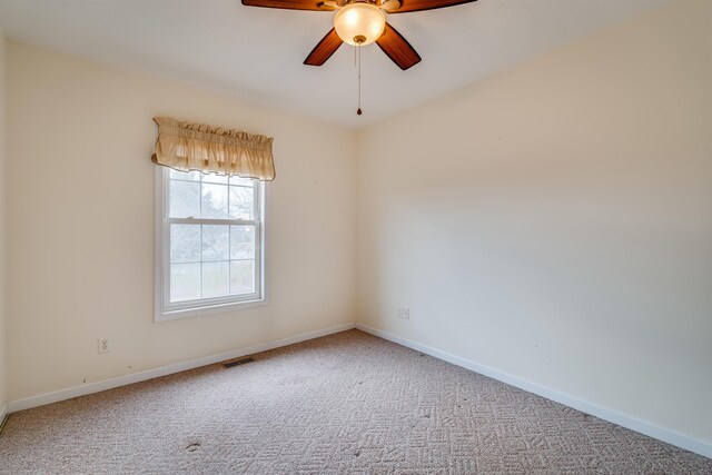 empty room featuring carpet floors and ceiling fan