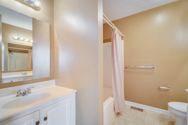 full bathroom featuring shower / bath combo, vanity, a textured ceiling, and toilet