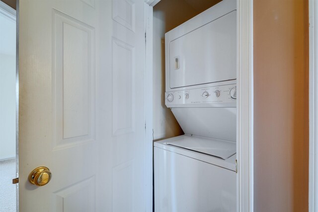 washroom with stacked washer / drying machine