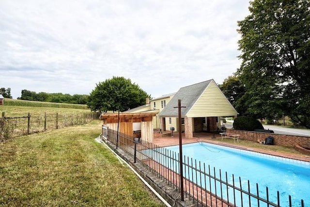 view of swimming pool with a storage structure, an outdoor structure, fence, a fenced in pool, and a patio area